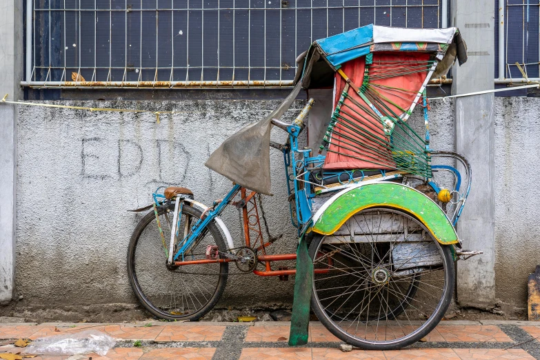 a rickshaw parked on the side of a building, inspired by Steve McCurry, pexels contest winner, verdadism, south jakarta, profile image, upcycled, half turned around