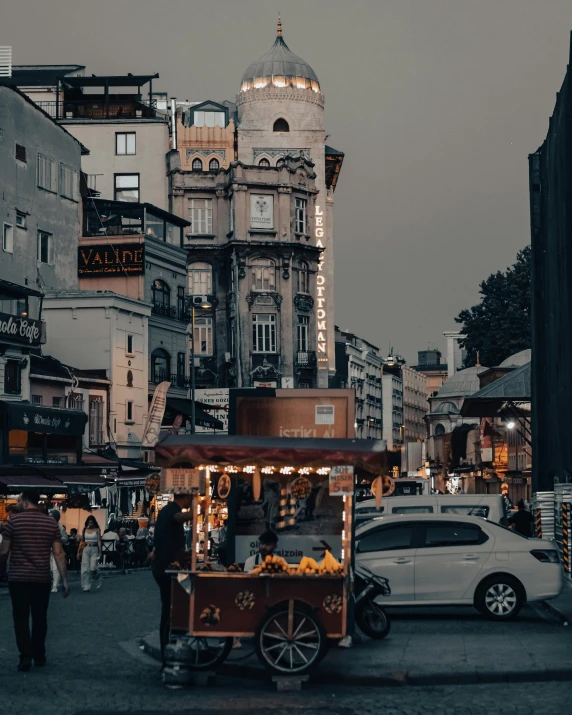 a street filled with lots of traffic next to tall buildings, pexels contest winner, art nouveau, middle eastern style vendors, thumbnail, late evening, turkish and russian