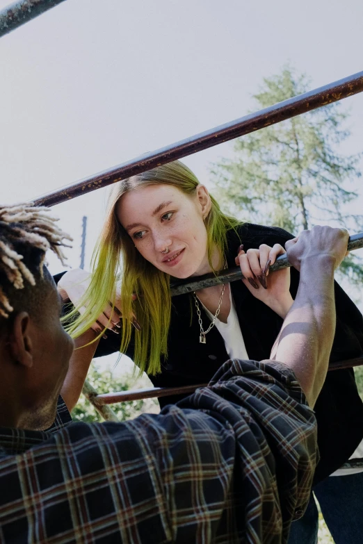 a man and a woman standing next to each other, an album cover, inspired by Elsa Bleda, trending on pexels, realism, people falling off a playground, bright green hair, lil uzi vert, sydney sweeney