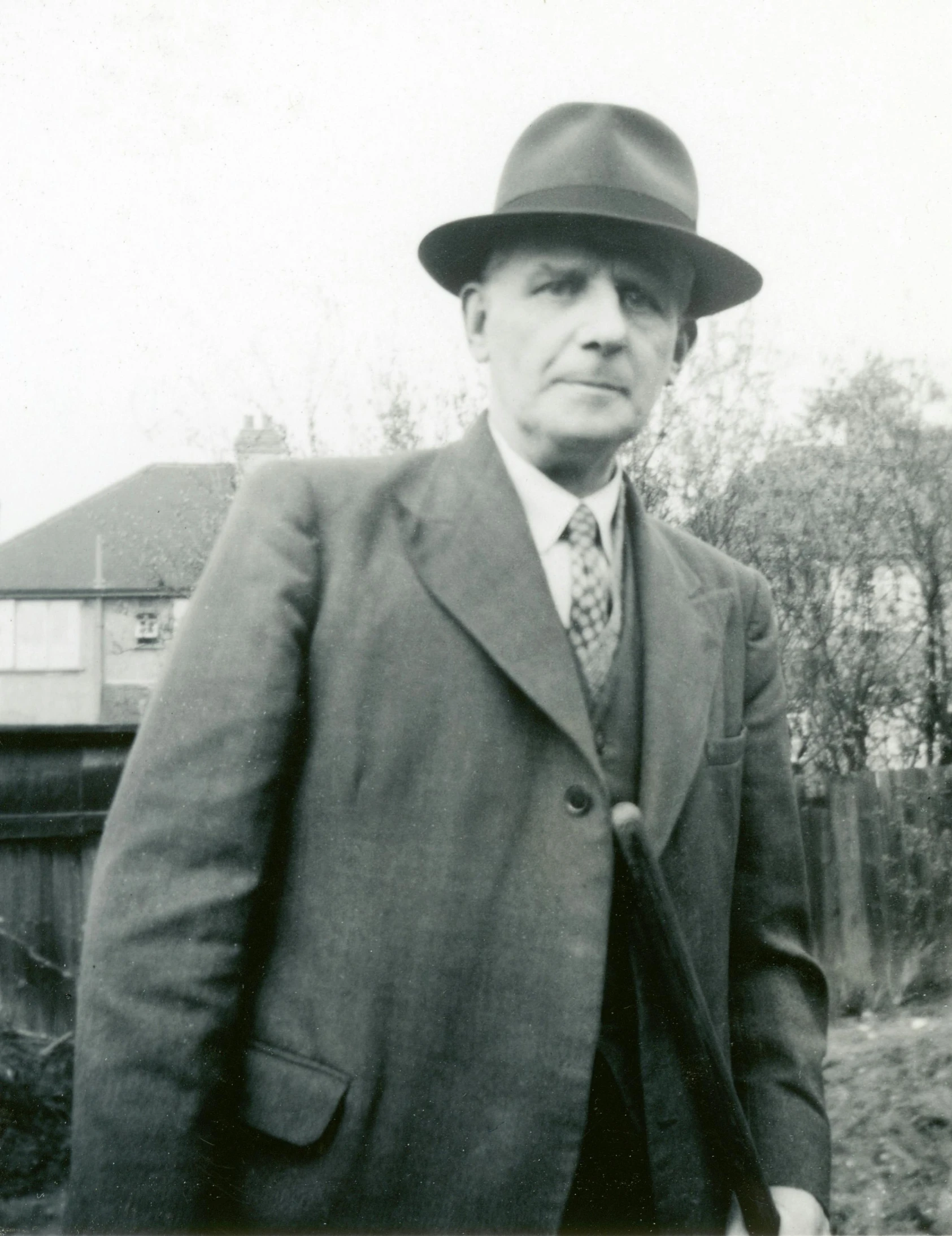 a black and white photo of a man in a suit and hat, a black and white photo, bauhaus, colour photograph, instagram picture, tolkien, 1950s press photo