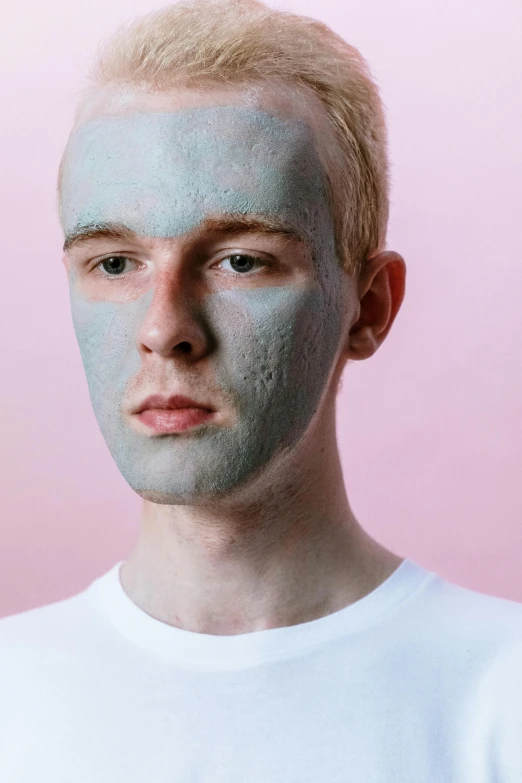 a man with a blue mask on his face, an album cover, inspired by Seb McKinnon, reddit, very light freckles, ignant, smooth pink skin, synthetic bio skin