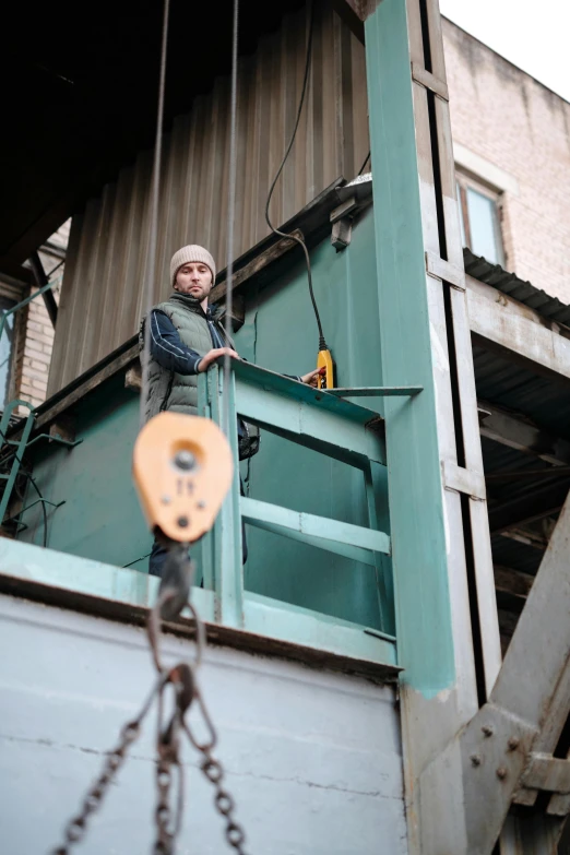 a man that is standing in the back of a truck, pexels contest winner, arbeitsrat für kunst, opposite the lift-shaft, hanging cables, in russia, coating a stubborn core.'