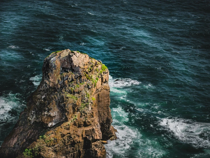 a large rock in the middle of the ocean, pexels contest winner, looking down a cliff, thumbnail, hziulquoigmnzhah, full frame image