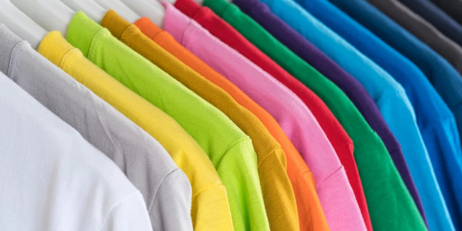 a row of colorful shirts hanging on a rack, pexels, color field, closeup of arms, clear colours, no - text no - logo, split dye