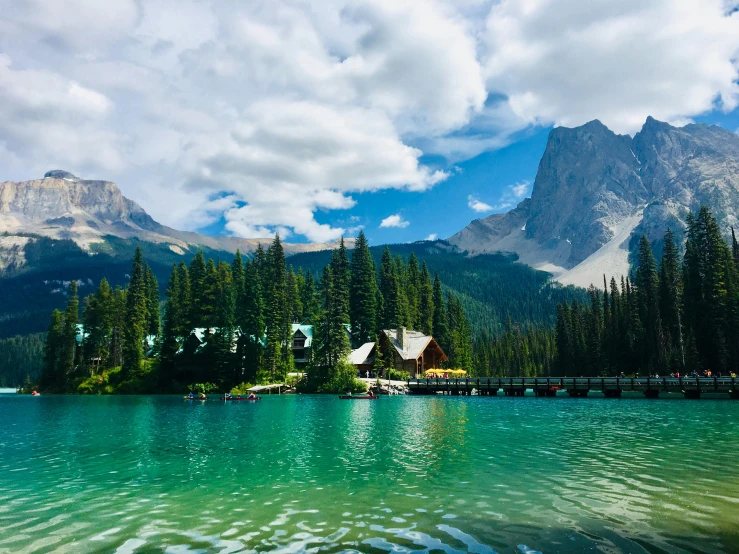 a large body of water with a mountain in the background, pexels contest winner, lake house, boards of canada, green water, parks and lakes