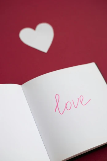 an open book with the word love written on it, greeting card, thumbnail, inside, promo image