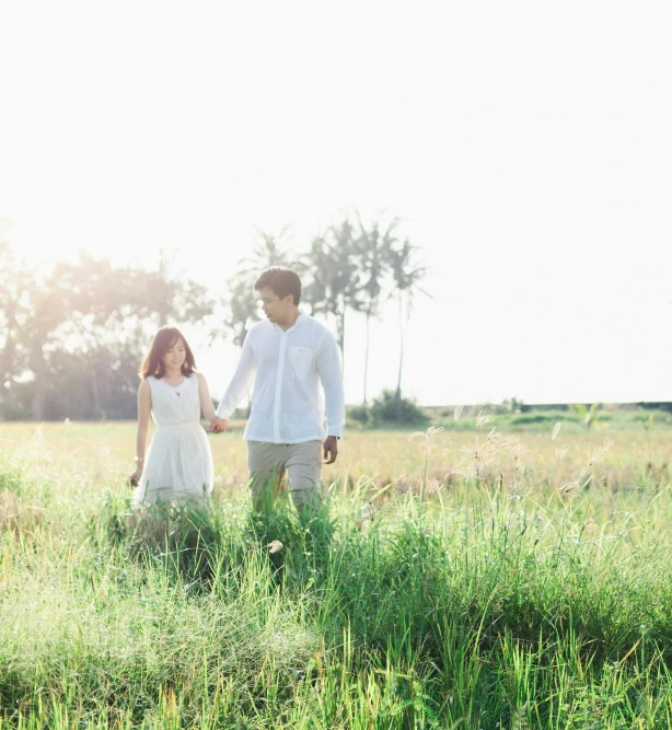 a man and a woman walking through a field, unsplash, high - key, sasai ukon masanao, romantic lead, sunny lighting