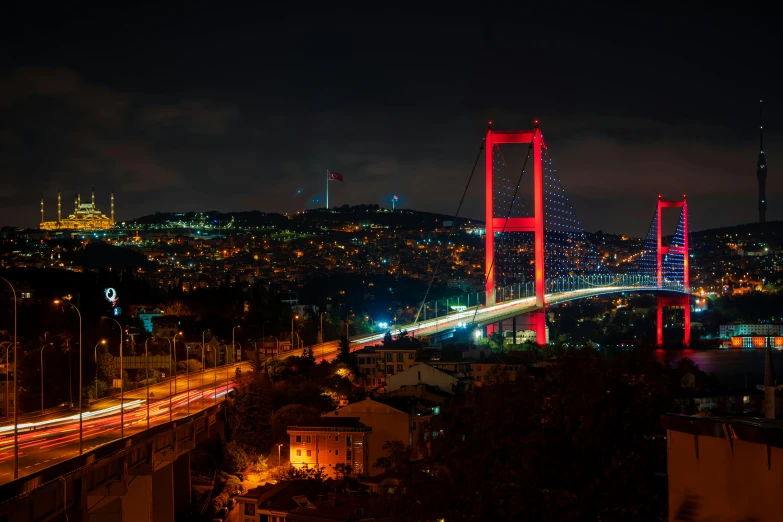 a view of a bridge over a city at night, by Yasar Vurdem, pexels contest winner, hurufiyya, 256x256, turkey, slide show, red lights