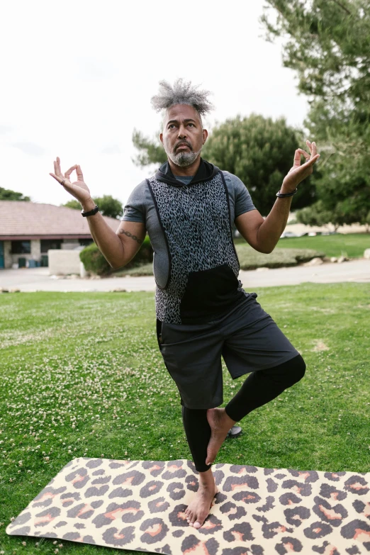 a man doing yoga on a leopard print mat, inspired by david rubín, unsplash, renaissance, standing in grassy field, wearing nike air mags, shrugging arms, aboriginal australian hipster