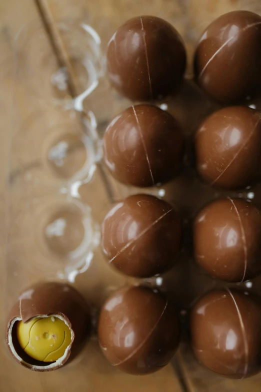 a group of chocolate balls sitting on top of a wooden table