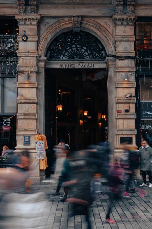 a crowd of people walking in front of a building