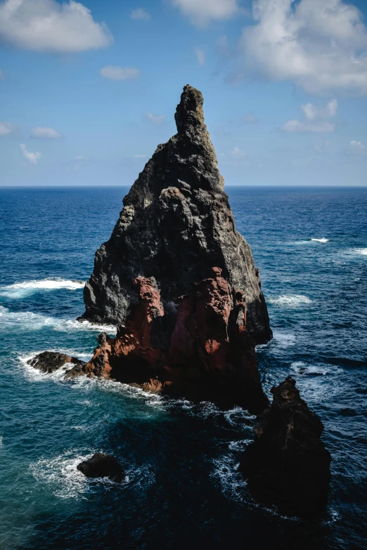a large rock in the middle of the ocean, asymmetrical spires, azores, towering high up over your view, slide show