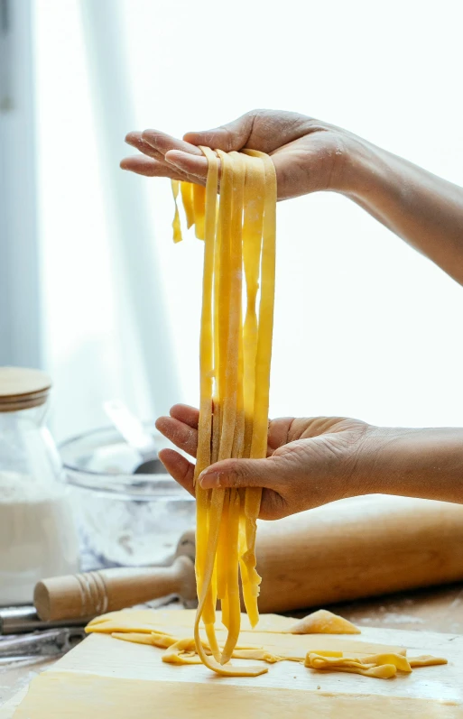 a close up of a person making pasta on a table, large tall, ribbon, 4l, lifestyle