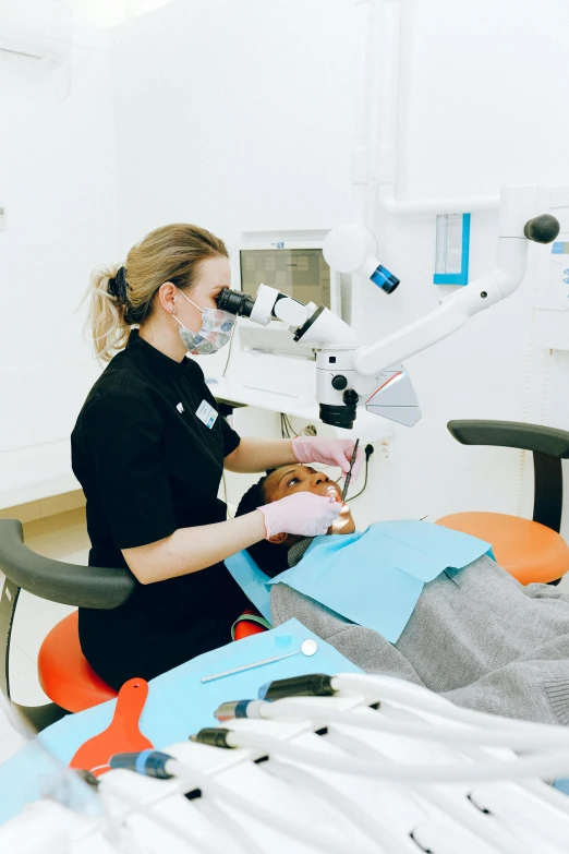 a woman getting her teeth examined by a dentist, by Rachel Reckitt, happening, surgery theatre, impactful, brown, thumbnail