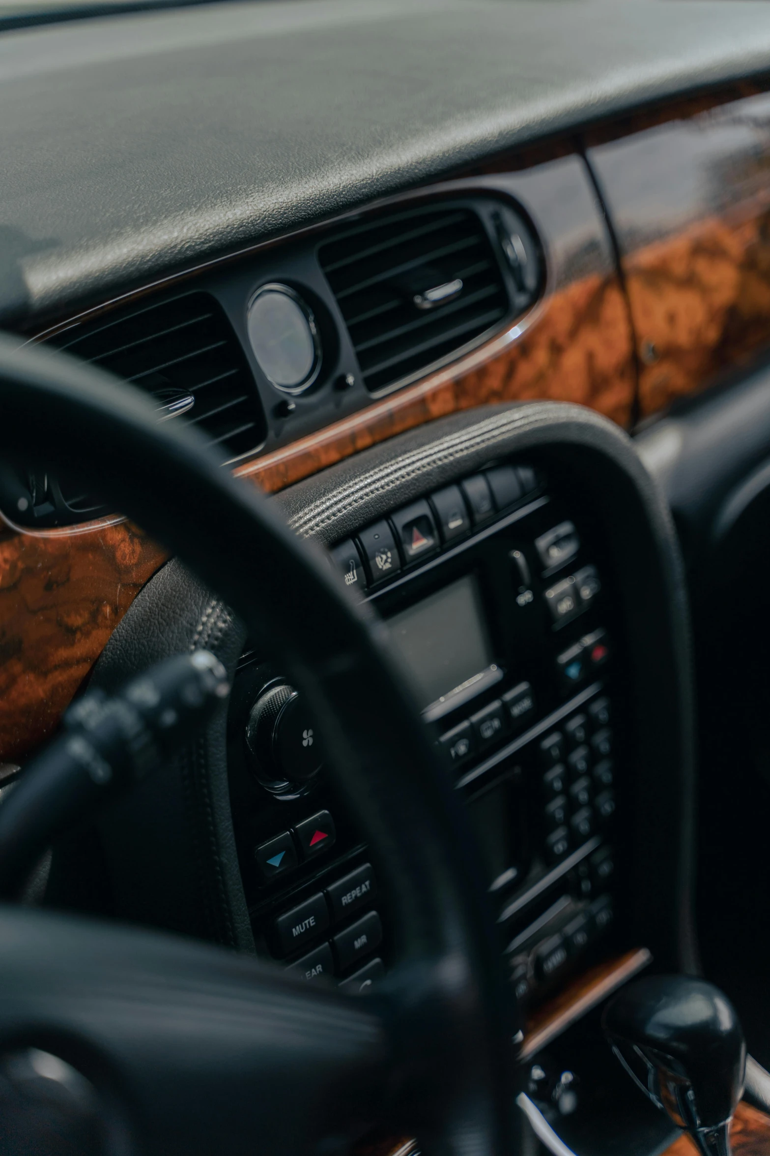 a close up of the dashboard of a car, renaissance, wood accents, paul barson, dark. no text, early 2 0 0 0 s