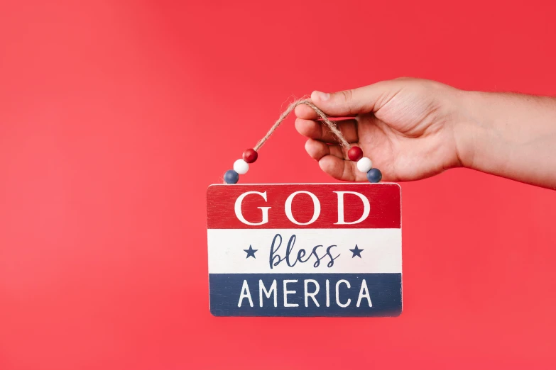 a person holding a sign that says god bless america, trending on pexels, folk art, ornament, uk, christian saint, profile image