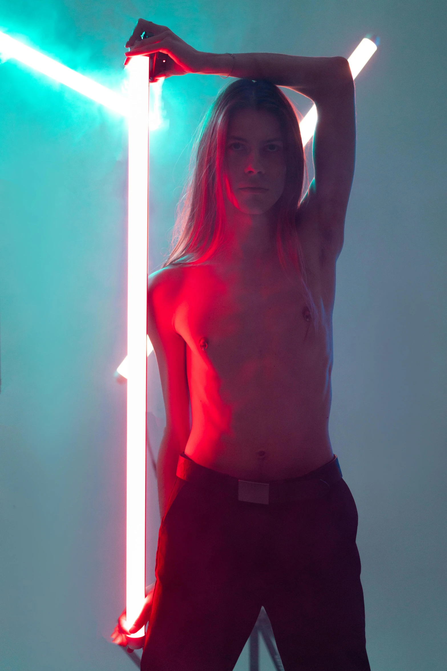 a shirtless man standing in front of a neon light, inspired by David LaChapelle, light and space, young with long hair, petra cortright, volumetric lighting. red, tall and slender