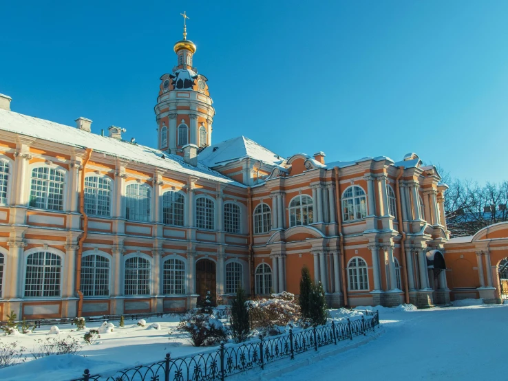 a large building with a clock tower on top of it, inspired by Vasily Surikov, pexels contest winner, rococo, covered with snow, exterior botanical garden, 000 — википедия, monastery