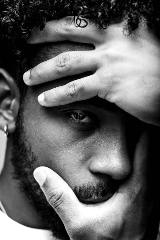 a black and white photo of a man with his hand on his face, a black and white photo, by Nadir Afonso, square, uploaded, eyes!, black man