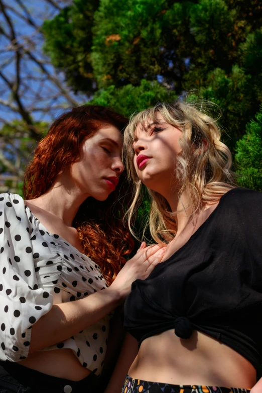 a couple of women standing next to each other, inspired by Nan Goldin, trending on pexels, renaissance, long blonde or red hair, polka dot, in the sun, 15081959 21121991 01012000 4k