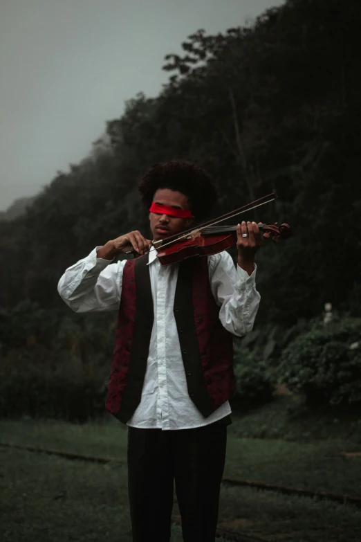 a man in a red mask playing a violin, an album cover, inspired by Gordon Parks, pexels contest winner, vanitas, samurai with afro, overcast day, childish gambino, red eyed