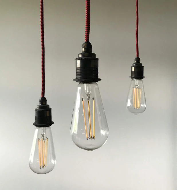 a bunch of light bulbs hanging from a ceiling, inspired by George Fiddes Watt, soft grey and red natural light, from left, carbon blac and antique gold, pendants