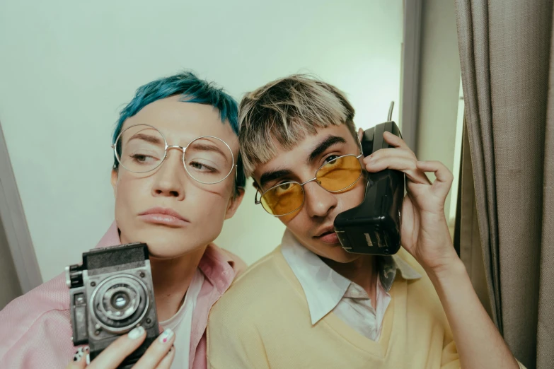 a man and woman taking a selfie in front of a mirror, inspired by Nan Goldin, trending on pexels, antipodeans, gucci glasses, an epic non - binary model, teal aesthetic, liam brazier and nielly