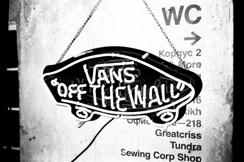 a black and white photo of a sign that says vans off the wall, by Jaime Colson, sots art, 👰 🏇 ❌ 🍃, backlighted, harry volk clip art style, wires hanging