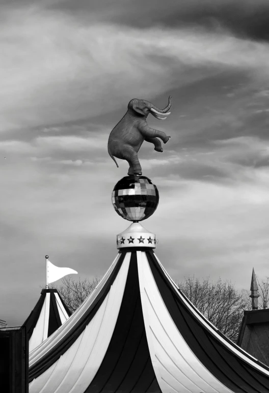 a black and white photo of a circus tent, a surrealist sculpture, magic realism, 🦑 design, elephant, horned, amusement park