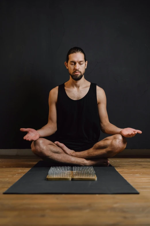 a man sitting in a lotus position on a yoga mat, by Benjamin Block, renaissance, he is holding a large book, transparent, promo image, ash thorp khyzyl saleem