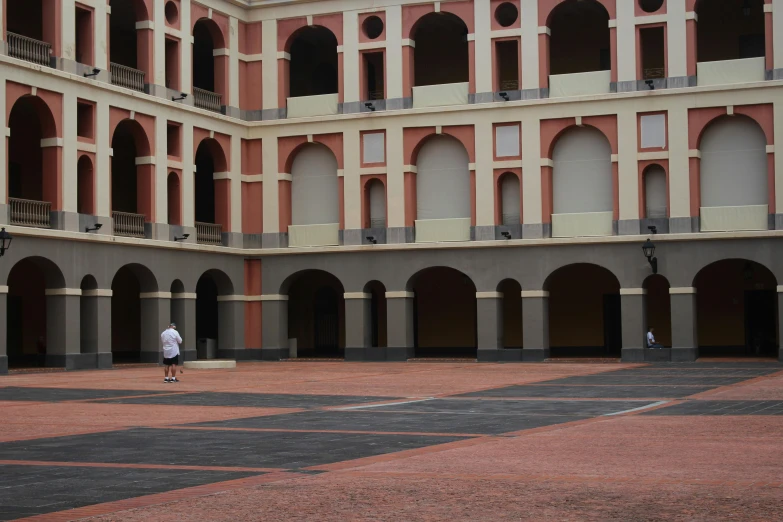 a man that is standing in the middle of a courtyard, inspired by Melozzo da Forlì, pexels contest winner, quito school, moody : : wes anderson, exterior view, réunion des musées nationaux, 2 5 6 x 2 5 6 pixels