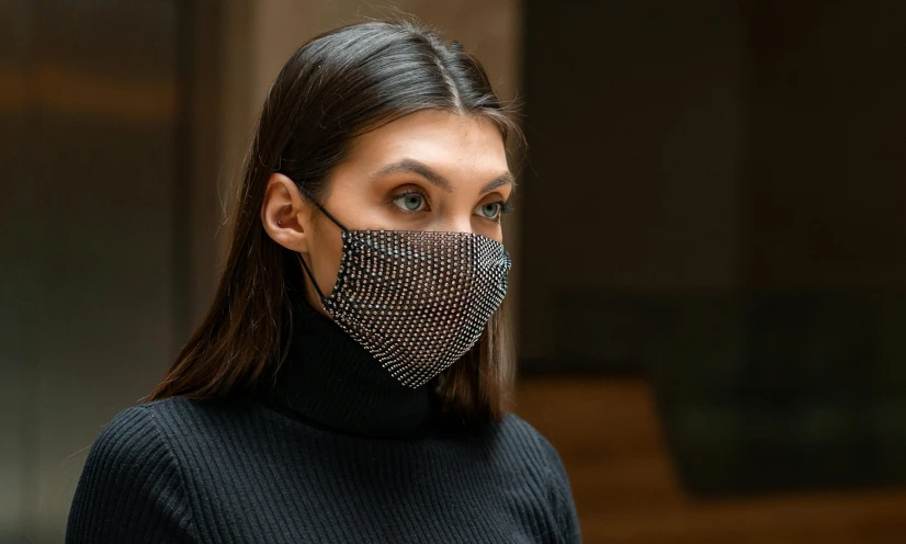a close up of a person wearing a face mask, by Nina Hamnett, trending on pexels, renaissance, chainmail, official product photo, black, made of crystal