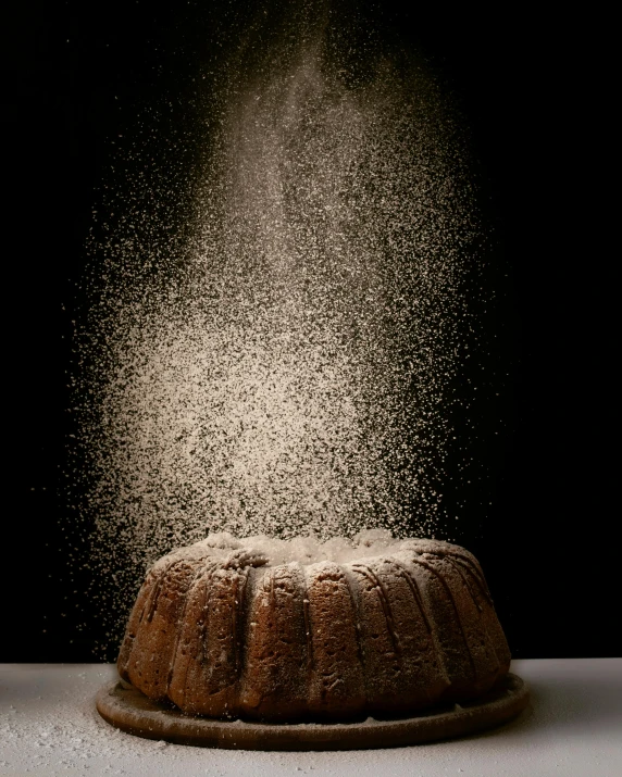 a bundt cake is sprinkled with powder, a stipple, by Andrew Domachowski, shutterstock contest winner, shot on hasselblad, volumetric backlighting, levitating sand, -step 50