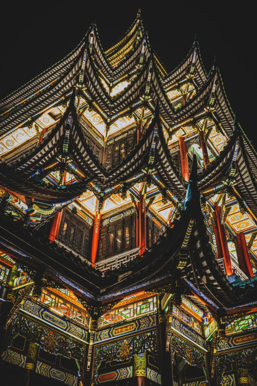 the top of a building lit up at night, a detailed painting, inspired by Wang Yi, pexels contest winner, cloisonnism, detail structure, inside her temple, china town, intricate geometry