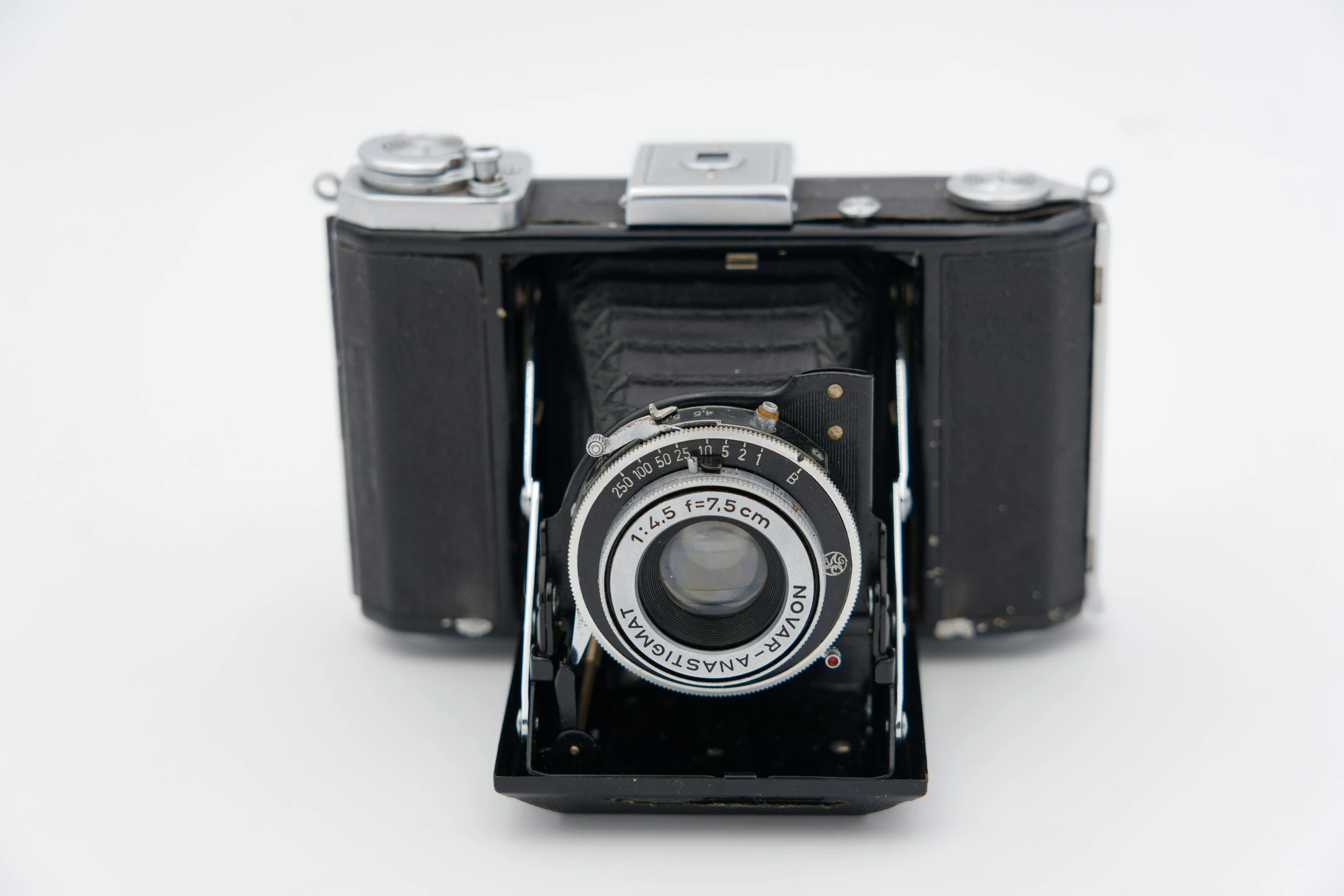 an old camera sitting on top of a table, by Niels Lergaard, bauhaus, detailed medium format photo, front view, a beautiful detailed orixa, on a white background