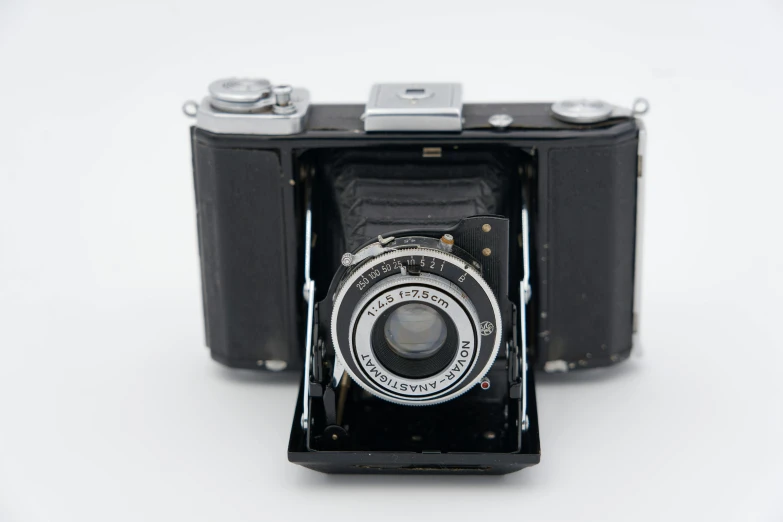 an old camera sitting on top of a table, by Niels Lergaard, bauhaus, detailed medium format photo, front view, a beautiful detailed orixa, on a white background