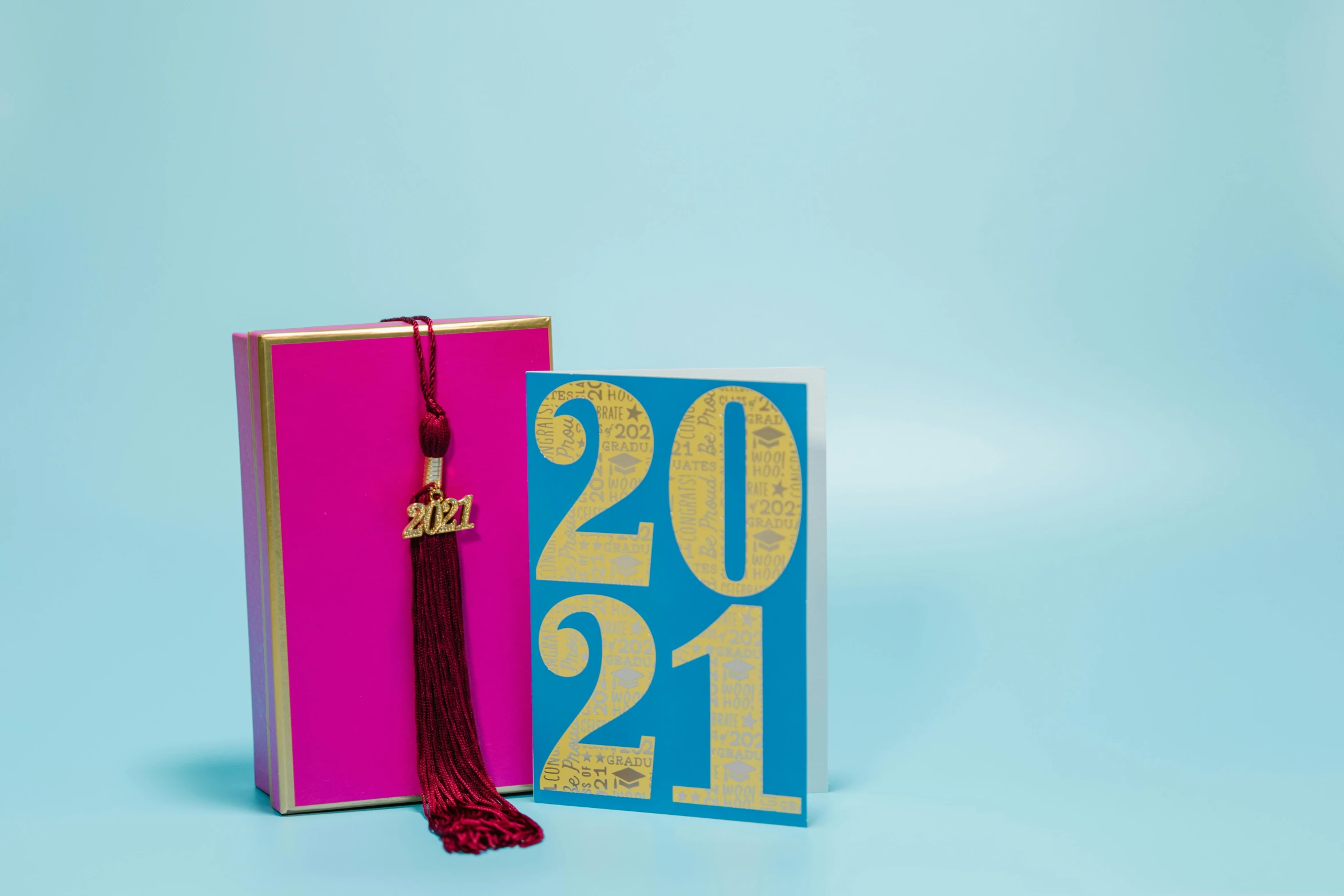 a book with a graduation cap on top of it, an album cover, by Julia Pishtar, fuchsia and blue, gold foil, 27, card