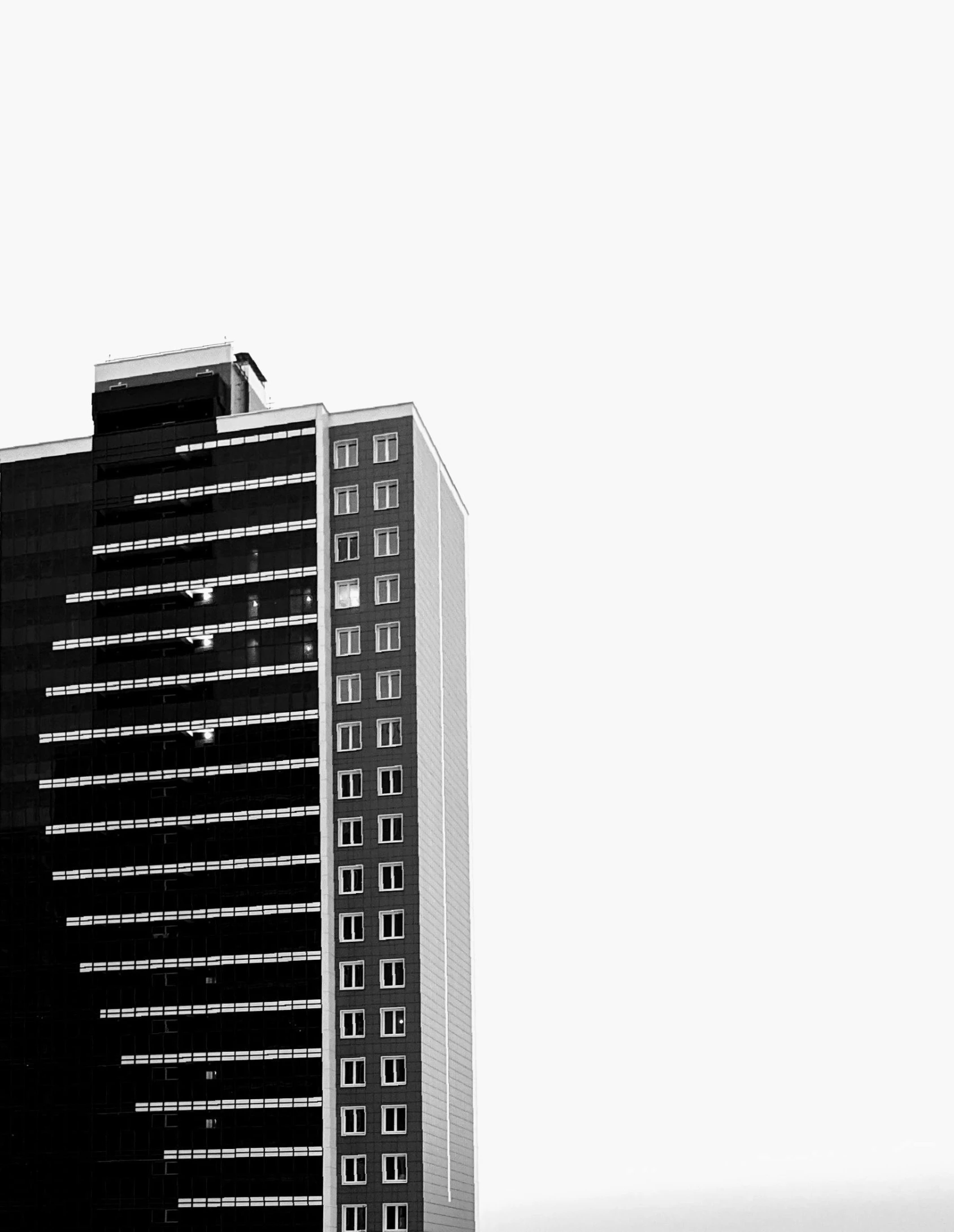 a black and white photo of a tall building, by Andrei Kolkoutine, unsplash, minimalism, isolated on white background, jovana rikalo, low detailed, realistic building