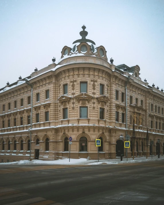 a large building sitting on the side of a road, pexels contest winner, art nouveau, with snow on its peak, rutkowskyi, thumbnail, lgbtq