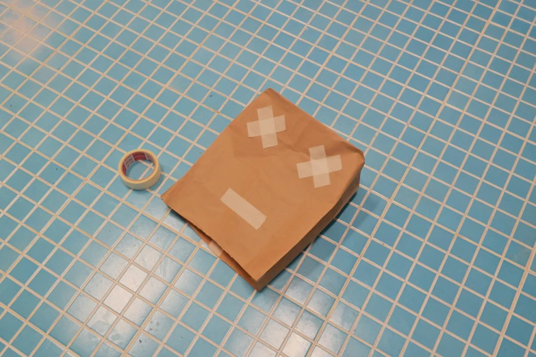 a brown paper bag sitting on top of a blue tiled floor, covered in bandages, kitbashing component, tearaway, next to a pool