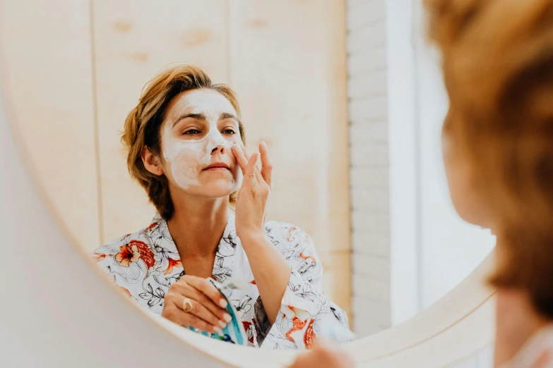 a woman that is standing in front of a mirror, perfect facial symettry, manuka, white face paint, background image