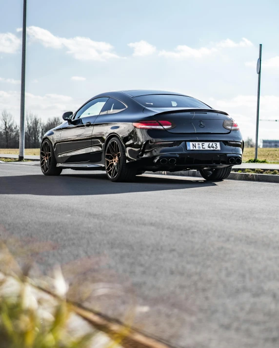 a black mercedes cla parked on the side of a road, by Julia Pishtar, pexels contest winner, square, panorama, brown tail, gtr xu1
