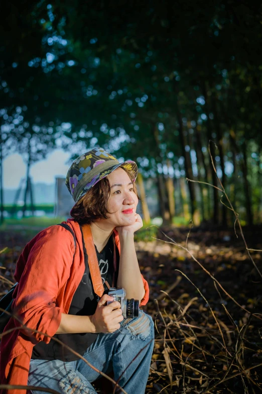 a woman sitting on a log in the woods, a picture, inspired by Kim Jeong-hui, pexels contest winner, headshot profile picture, shot with a dslr, vietnamese woman, icon
