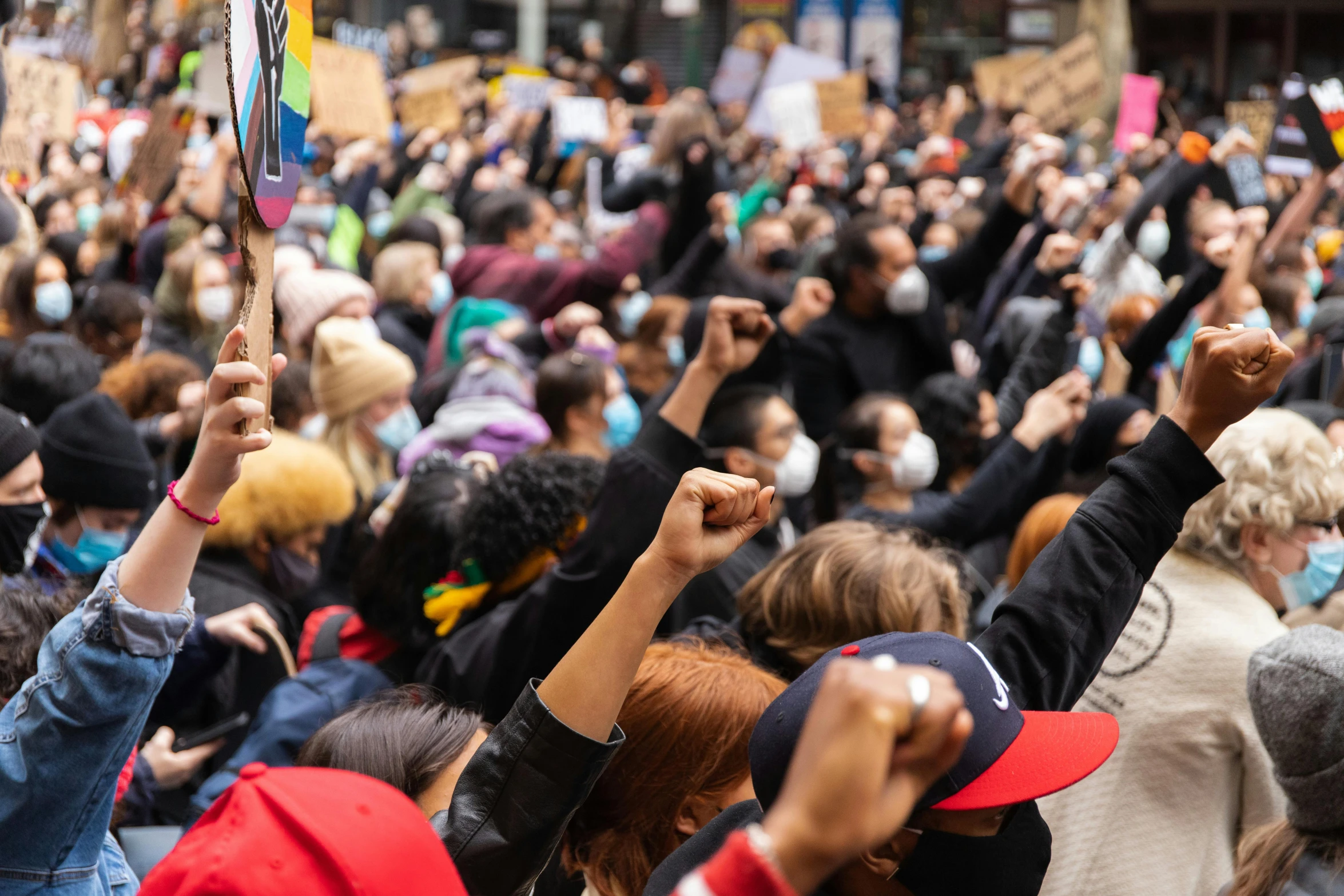 a crowd of people with their hands in the air, lachlan bailey, raised fist, photo of a black woman, protest