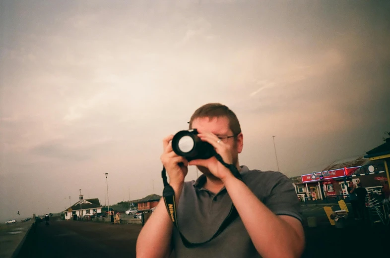 a man taking a picture with a camera, inspired by Louis Faurer, unsplash, art photography, william eggleston, medium format, 2000s photo