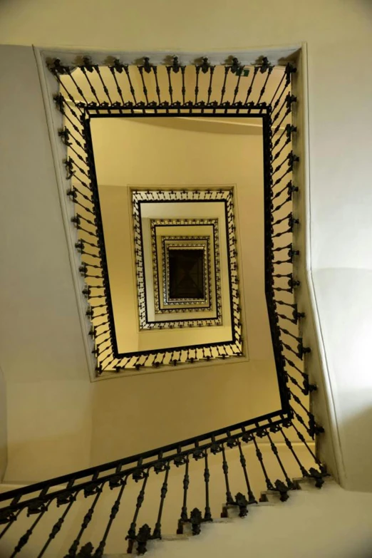 a spiral staircase with a mirror above it, inspired by Rodolfo Escalera, vienna secesion style, square, wikimedia, straight camera view