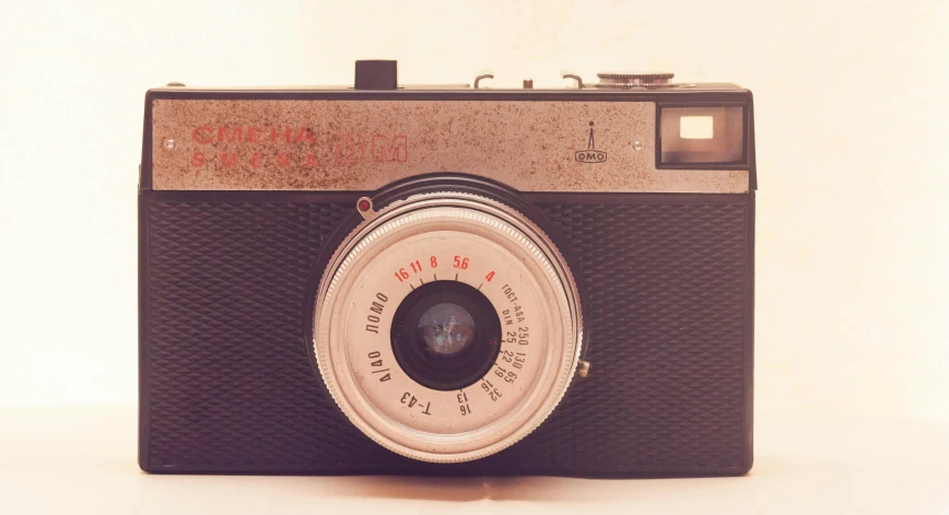 a close up of a camera on a table, a picture, inspired by Diane Arbus, pixabay contest winner, photorealism, in retro colors, on a pale background, panoramic photography, pinhole