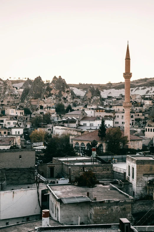 a view of a city from the top of a hill, a colorized photo, trending on pexels, hurufiyya, minarets, in the foreground a small town, a quaint, 8 x