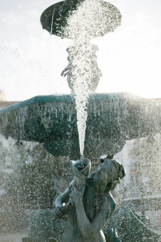 a close up of a fountain with water coming out of it, a statue, winter sun, men and women, seen from below, drinking