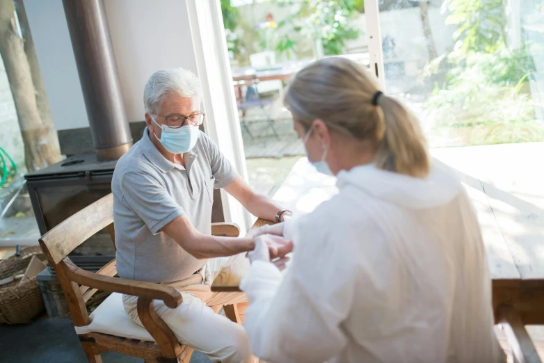 a couple of people that are sitting on a bench, old man doing with mask, bandage on arms, medical photography, brown